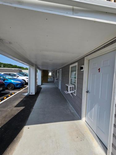a building with a white door and a parking lot at Vacation Inn in Saco