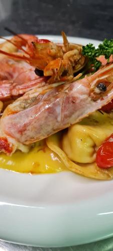 a plate of food with fish and sauce at Hotel Danieli La Castellana lago di Garda in Brenzone sul Garda