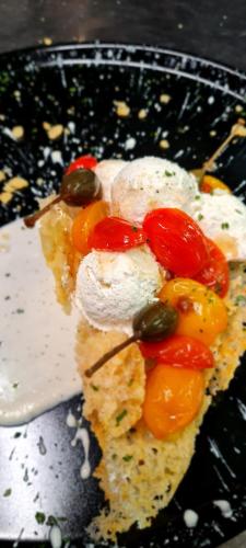 a plate of food with tomatoes and cheese on it at Hotel Danieli La Castellana lago di Garda in Brenzone sul Garda