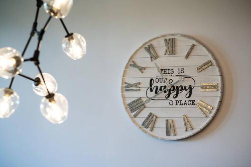 a clock on a wall with the words yes is our happy place at Tremblant Prestige - Horizon 1-203 in Mont-Tremblant