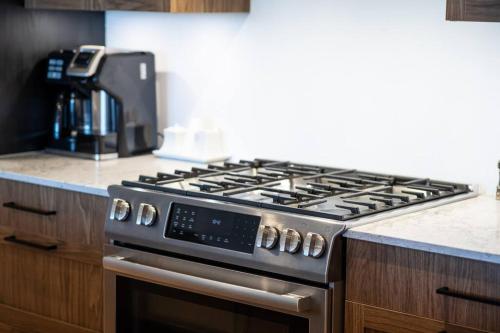 a stainless steel stove top oven in a kitchen at Tremblant Prestige - Horizon 1-203 in Mont-Tremblant