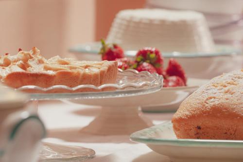 a table with a cake and a plate of cake at Agriturismo Bio Aia della Colonna in Saturnia