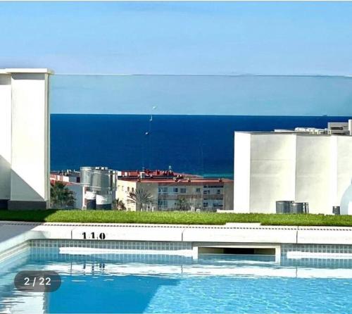 a swimming pool in front of a building at Sunset view * Swimming pool* A/C in Tarifa