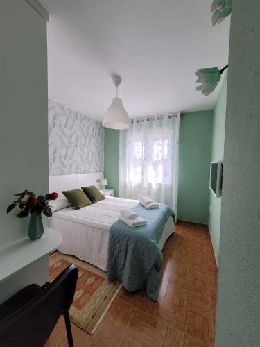 a bedroom with a large bed in a room at La Tablada in Recuevo