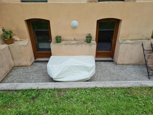 a mattress sitting on the ground in front of a building at Appartement Rez-de-jardin Terrasse in Aulus-les-Bains