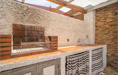 a kitchen with a stone wall and a counter top at Nice Home In Adra With Private Swimming Pool, Can Be Inside Or Outside in Adra