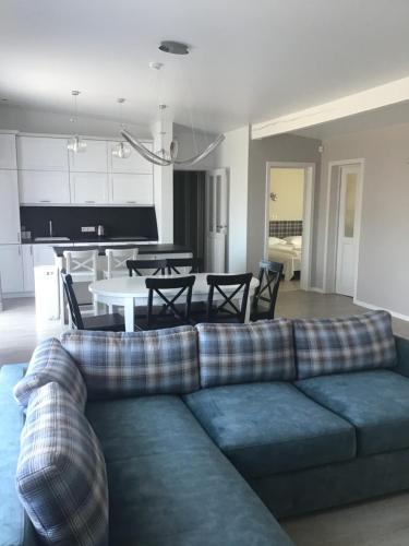 a living room with a couch and a table at Ramios bitės in Palanga