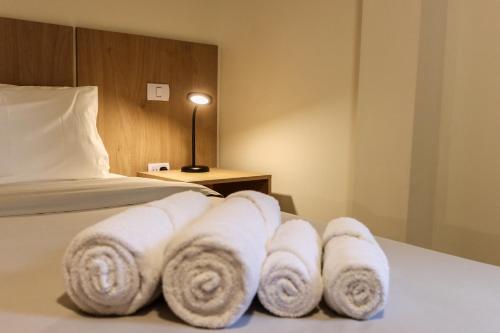 a hotel room with towels on a bed at Mirador de Alem Apartments in Ushuaia