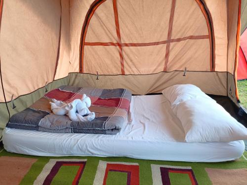 a bed in a tent with two teddy bears on it at Kintamani Adventures 'Life Hurt, Nature Heal' in Kintamani