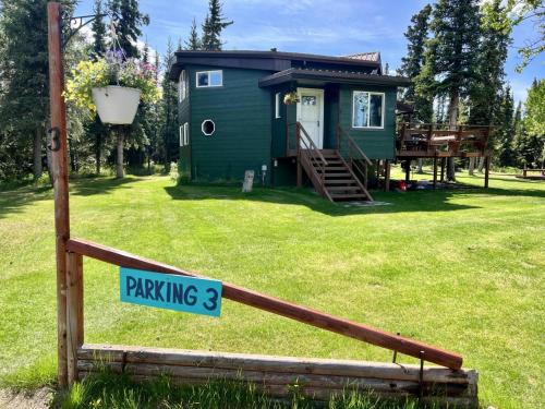 a tiny house with a sign that reads parking at Denali Natl Park 3 Bedroom Home on 5 Acres, hiking and wildlife in Healy