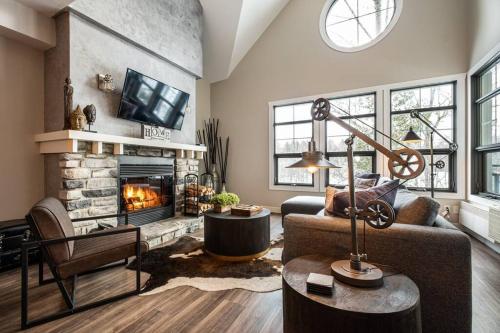 a living room with a couch and a fireplace at Tremblant Prestige - Les Eaux 227-5 in Mont-Tremblant