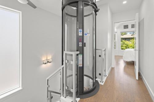 a large glass elevator in a room at Oswego Paradise Retreat in Victoria
