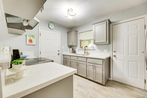 a kitchen with white cabinets and a white counter top at Pet-Friendly San Juan Vacation Rental with Grill! in San Juan