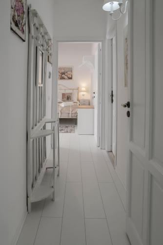 a hallway with a white tiled floor and a bedroom at TAM Vacanze B&B in Cinisi