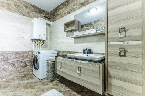 y baño con lavabo y lavadora. en Cozy Villa w Terrace and Garden in Beykoz Istanbul, en Estambul