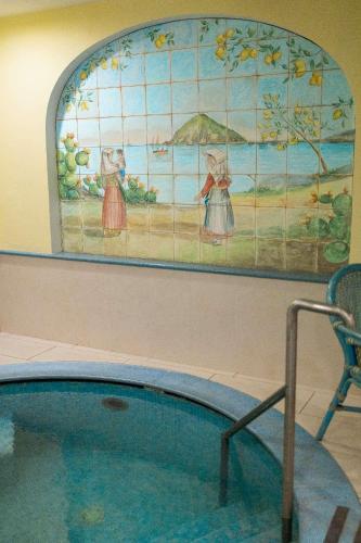 a painting on a wall next to a swimming pool at Hotel Royal Terme in Ischia