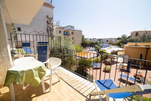 a balcony with a table and chairs and a view of a city at Hotel Royal Terme in Ischia