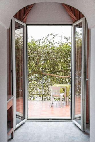 an open door to a patio with a bench outside at Hotel Royal Terme in Ischia