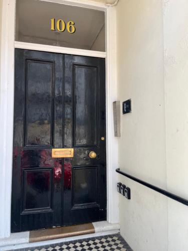 a black door with the number on it at Studio flat Brighton Hove border in Brighton & Hove