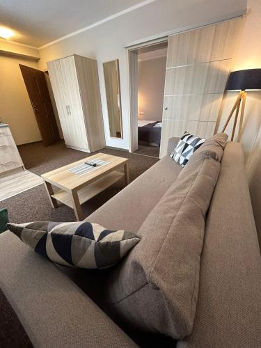 a living room with a couch and a table at Old Tree Villa & Restaurant in Oświęcim