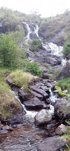 a stream of water on the side of a mountain at Paraíso Ortegal in Feás