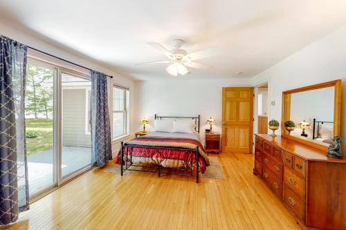 a bedroom with a bed and a ceiling fan at Four Seasons in Ellsworth
