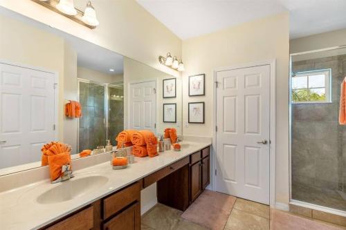 a bathroom with a sink and a large mirror at 535 -Villa Belvedere, A Stunning, Spacious 5 Bed Lake View Home with Pool and Spa in Davenport