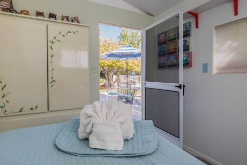 a room with a bed with a chair and an umbrella at Kapila Gardens Family Retreat w/ private pool in Cottonwood