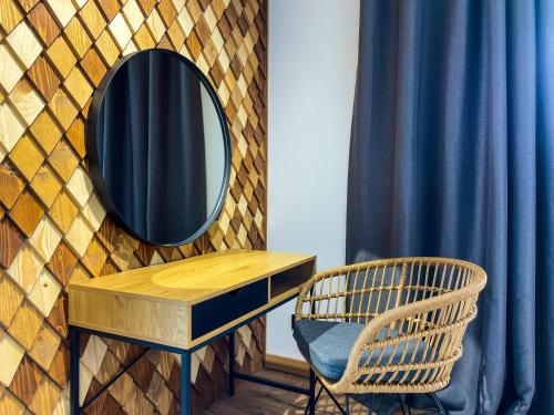 a dressing table with a mirror and a chair at Carpathians View in Krivopolʼye
