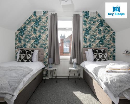 a bedroom with two beds and a window at "Keysleeps Central Contractors & Leisure - Nottingham - Free Parking" in Nottingham