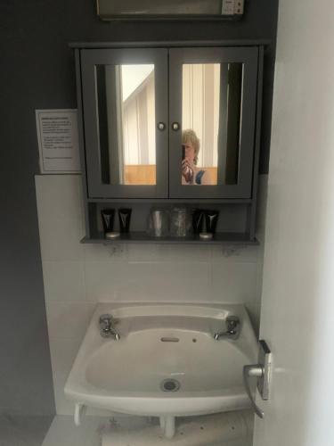 a person taking a picture of a bath tub in a bathroom at Burnett Arms in Inverurie