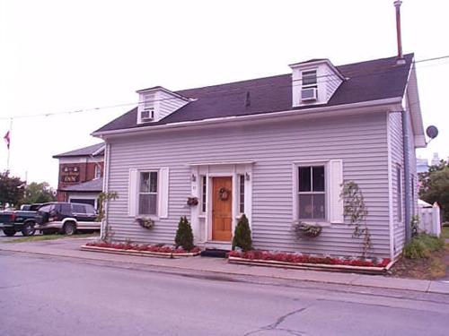 a white house on the side of a street at The King George Inn in Cobourg
