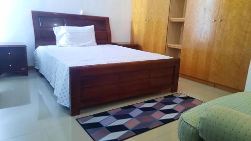 a bedroom with a bed and a checkered floor at My Flat 2 in Praia