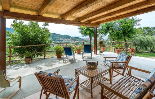 a patio with chairs and tables and a wooden roof at Rosetta House in Castellammare di Velia