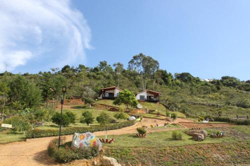 a view of a garden with houses on a hill at Mesa De los Santos, Balcones De los Santos Cabaña Lounge Eucalipto in Los Santos