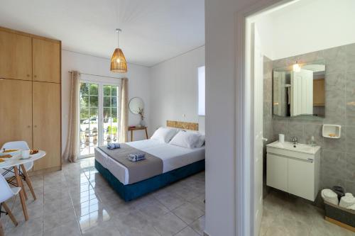 a bedroom with a bed and a bathroom at White House studios & apartments in Argostoli