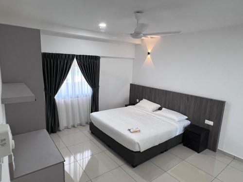 a bedroom with a bed and a window at Menara Sentral at Juru Sentral in Bukit Mertajam
