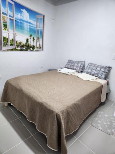 a bedroom with a large bed with a large window at Casa Linda Vista in Guanajuato