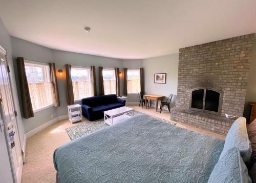 a living room with a bed and a fireplace at The Edenwild Boutique Inn in Lopez