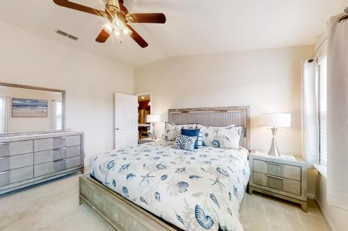 Schlafzimmer mit einem Bett und einem Deckenventilator in der Unterkunft Serenity by the Sea in St. Augustine