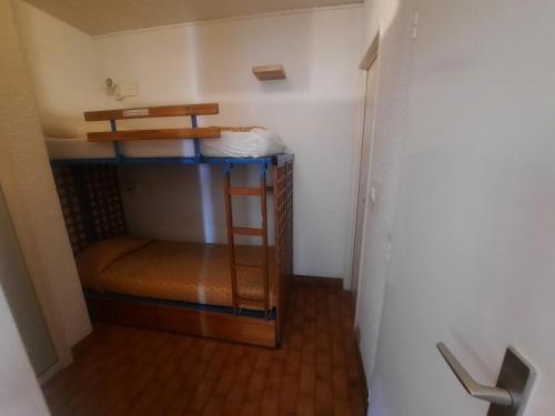 a small room with a bunk bed with a ladder at Le Golfe bleu in Roquebrune-Cap-Martin
