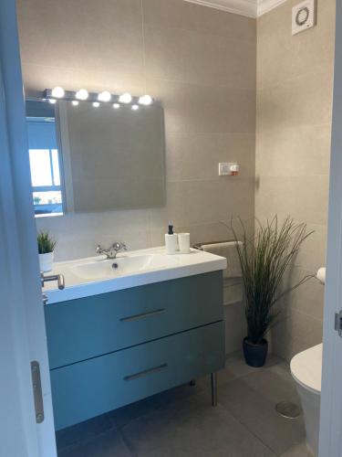 a bathroom with a white sink and a mirror at Precioso apartamento moderno in Málaga