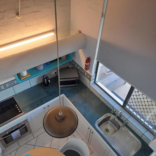 an overhead view of a small kitchen with a sink at Resort Loft & Spa Villa #8 in Mandurah