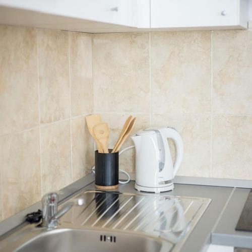 a kitchen counter with a sink and a toaster at Apartman Maris in Split