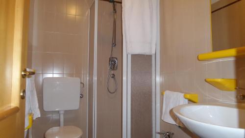 a bathroom with a sink and a toilet and a shower at Albergo Ristorante K2 in Roana