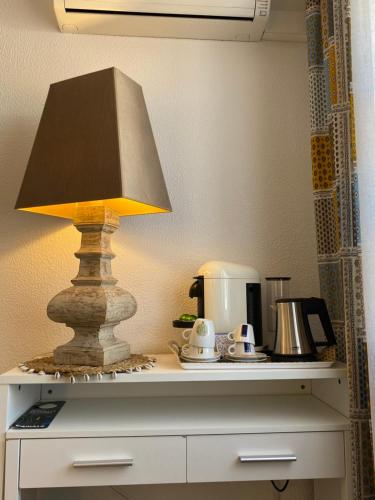 a lamp sitting on top of a table at Hôtel Le Neptune en Camargue in Saintes-Maries-de-la-Mer