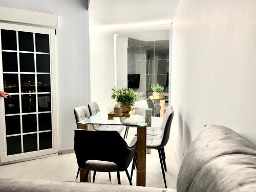 a living room with a table and chairs and a couch at Martina & Playa in Sanxenxo