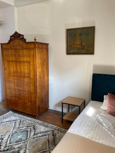 Schlafzimmer mit einem Bett und einem Holzschrank in der Unterkunft Villa Italiana pokoje z prywatnymi łazienkami & Odnowa Biologiczna in Gdynia