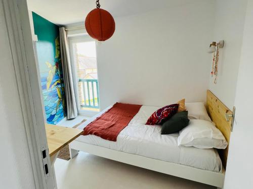 a bedroom with a bed with a basketball on the wall at Coco bay 2 in Saint-Benoît-des-Ondes
