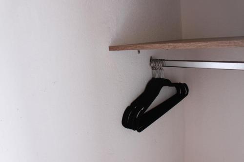 a black object is hanging on a wall at Mesa De los Santos, Balcones De los Santos Cabaña Lounge Eucalipto in Los Santos